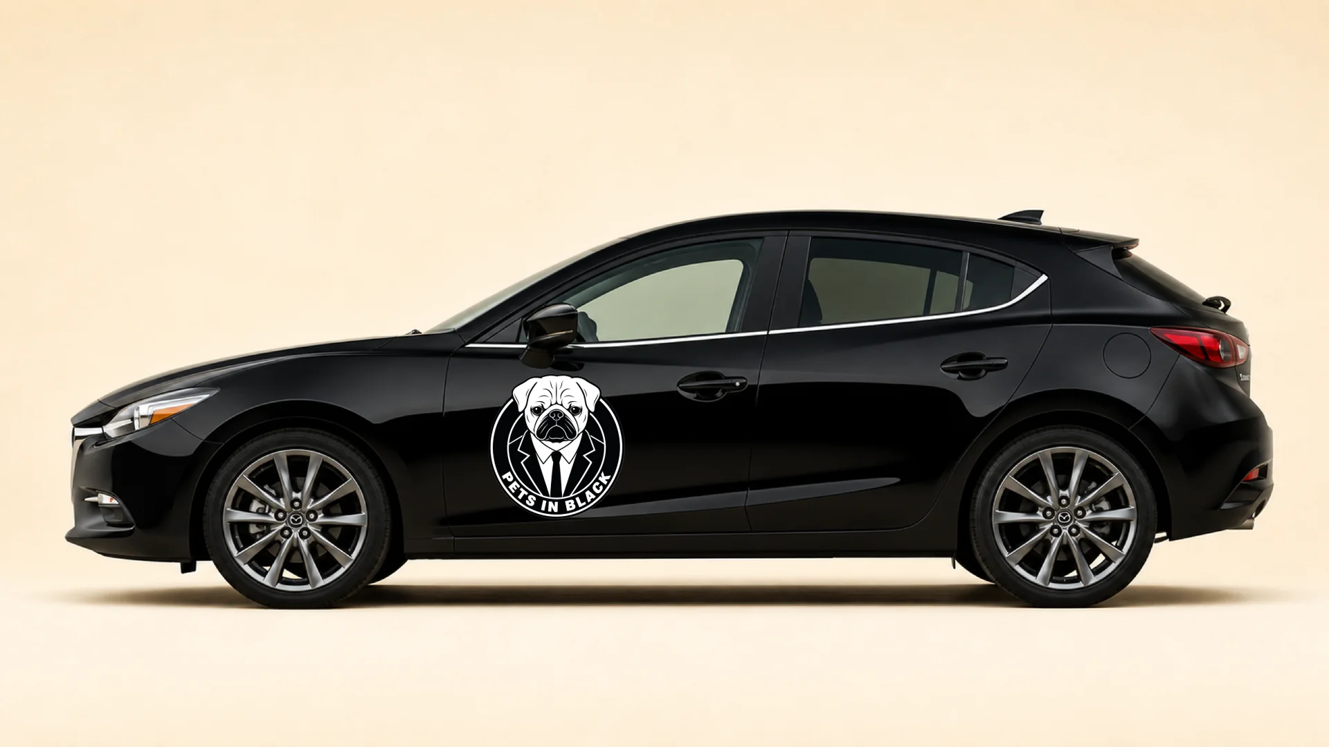 The black Pets In Black hatchback, emblem on the door